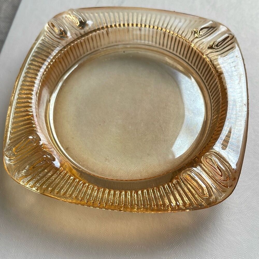 Vintage mid century Carnival glass ashtray. Peach in color.